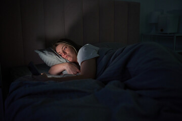 Late-Night Phone Scroll Under Soft Bedside Light
