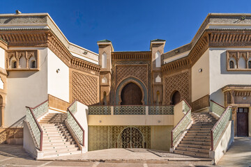 Moroccan Mosque Exterior With Tall Minaret And Ornate Entrance Under Blue Sky, Agadir
