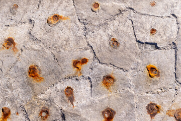 固定した金具が錆びて風化した石組みの背景