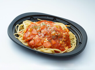 Delicious takeout spaghetti with rich tomato sauce and cheese served in a modern black container