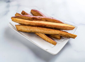 Delicious sweet potato fries on white plate