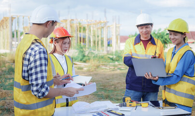Male and female engineers who are Asian professionals in the construction industry focus on village design and architecture to create sustainable houses for people to rent and sell.