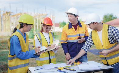 Male and female engineers who are Asian professionals in the construction industry focus on village design and architecture to create sustainable houses for people to rent and sell.
