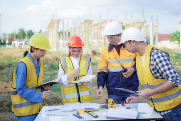 Male and female engineers who are Asian professionals in the construction industry focus on village design and architecture to create sustainable houses for people to rent and sell.