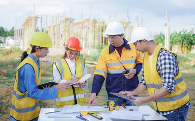 Male and female engineers who are Asian professionals in the construction industry focus on village design and architecture to create sustainable houses for people to rent and sell.