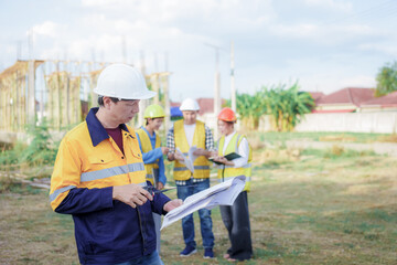 Male and female engineers who are Asian professionals in the construction industry focus on village design and architecture to create sustainable houses for people to rent and sell.