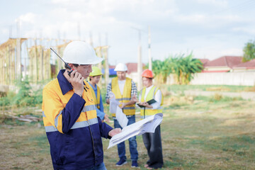 Male and female engineers who are Asian professionals in the construction industry focus on village design and architecture to create sustainable houses for people to rent and sell.