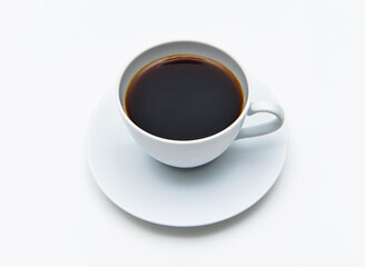 Steaming hot black coffee in a clean white cup and saucer ready for that morning energy boost