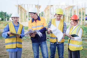 Male and female engineers who are Asian professionals in the construction industry focus on village design and architecture to create sustainable houses for people to rent and sell.
