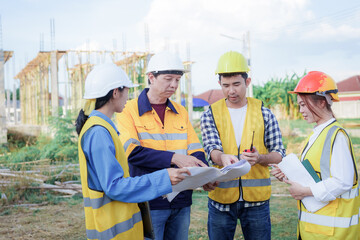 Male and female engineers who are Asian professionals in the construction industry focus on village design and architecture to create sustainable houses for people to rent and sell.