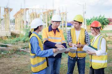 Male and female engineers who are Asian professionals in the construction industry focus on village design and architecture to create sustainable houses for people to rent and sell.