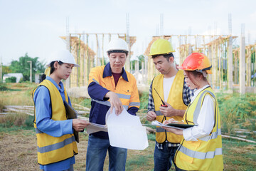 Male and female engineers who are Asian professionals in the construction industry focus on village design and architecture to create sustainable houses for people to rent and sell.