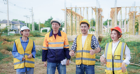 Male and female engineers who are Asian professionals in the construction industry focus on village design and architecture to create sustainable houses for people to rent and sell.