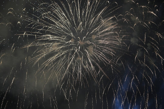 Spectacular Golden Fireworks Exploding in the Night Sky with Digital Noise and Grain Texture for Celebration Background