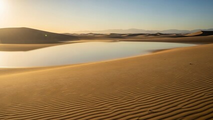 Fototapeta premium Golden Hour Oasis - Serene Desert Lake Reflecting the Warm Sunset Sky Amidst Rippled Sand Dunes.