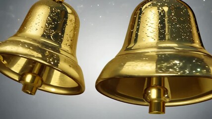 Shiny golden bells with water droplets on soft background symbolizing holiday, sound and celebration