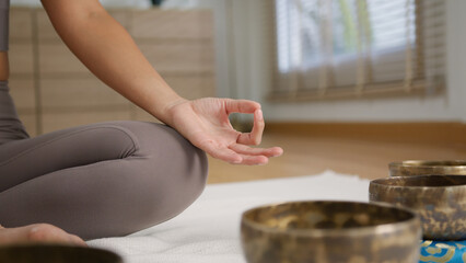 Serene sound healing session with tibetan singing bowl, mindful meditation hand mudra mat, warm home light and calm atmosphere encourage peaceful focus Sound Healing Tibetan singing bowl