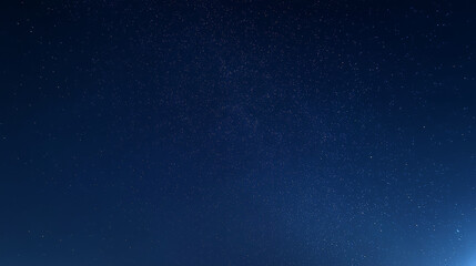 Obraz premium Stars fill the night sky over a dark landscape during clear conditions in late evening hours