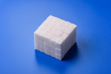 Sweet white sugar cubes as a source of glucose. White sugar cubes as a food background