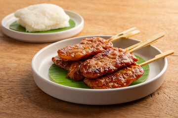 Grilled Pork With Sticky Rice.Thai styled BBQ Pork in white plate.