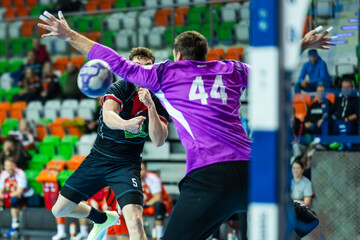 player throws ball next to the goalkeeper during handball match