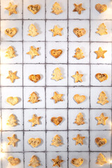 Home baked crackers cut in heart, star and Christmas tree shapes for a Christmas meal