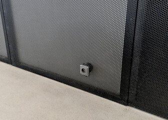 detail of perforated metal panel, part of server cabinet server rack or data cabinet optimal airflow ventilation, protected internal equipment from damage or unauthorized access, wall socket. wall cla