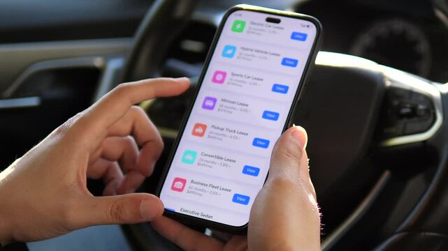 The hesitation before a major financial commitment. This shot captures a driver thoughtfully tapping his phone while reviewing various leasing proposals, embodying the universal moment of weighing