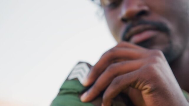 Sergeant Arranges Insignia, Sergeant Carefully Straightens Insignia Before Participating In Formation, Dedicated Military Officer Meticulously Positions Rank Insignia On Camouflage Sleeve Attire