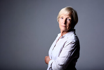 Senior woman portrait solid color background