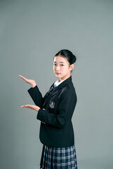 A Korean school woman, on a solid color background,Giving directions with one hand, Blazer uniform