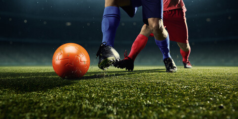 Naklejka premium Close range two football players boots in contact with ball. Concept of soccer boot detail, confident control, professional equipment performance, technical precision, gear promo, athletic focus.