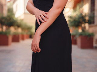 Young woman in elegant black dress walking in cozy old town Keleci, Antalya, Turkey during summer day. female traveler discover interesting places and popular attractions