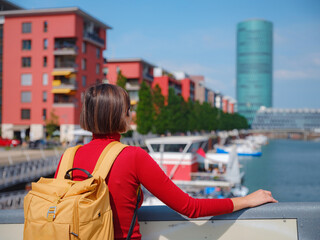 Tourist woman explores modern Frankfurt,