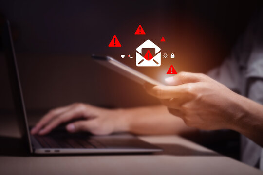person typing on laptop receives scam notification, illustrating cybersecurity risk and data breach threat, Spam mail pop-up warning. E-mail inbox with spam virus message, Trash and junk mail, scam. - Powered by Adobe