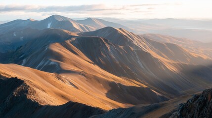 Naklejka premium Mountains under sunset light with large slopes and distant peaks