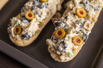 Bread Topped with Cheese Mixture and Olives – Ready to Bake