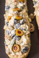 Bread Topped with Cheese Mixture and Olives – Ready to Bake