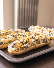 Bread Topped with Cheese Mixture and Olives – Ready to Bake
