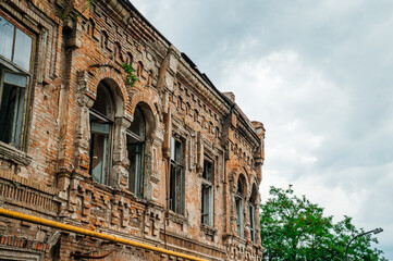 an old brick building with broken windows