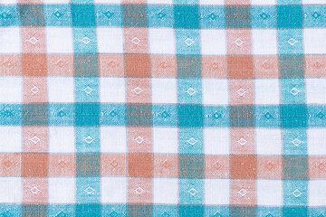 Orange, green and white plaid fabric texture. Textile backdrop