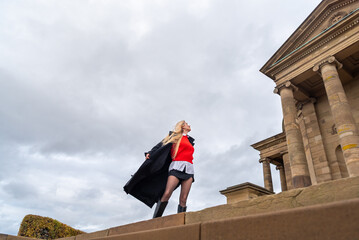 Low angle view with woman enjoying the wind on a sunny winter day