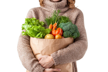 Woman holding grocery bag filled with vegetables on transparent background