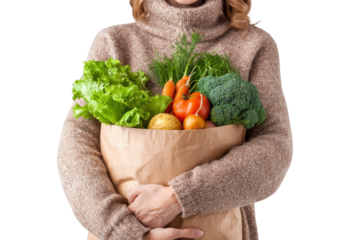 Woman holding grocery bag filled with vegetables on transparent background