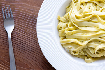Close-Up of Creamy Pesto Tagliatelle Pasta
