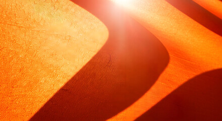 Abstract orange glowing background with fiery waves, light motion, and warm energy