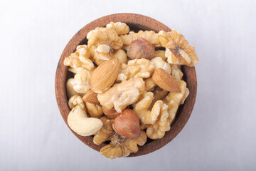 Rustic wooden bowl with a mix of nuts.