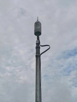 View lightning rod, also known as an air terminal or lightning conductor, mounted on a pole.