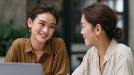 Indoor business meeting two women engaging in collaborative conversation in a modern office