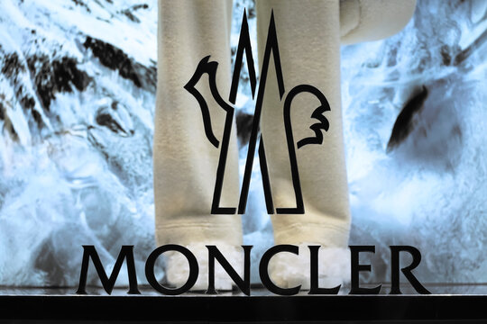 Honolulu, HI - Jan. 22, 2025: Trendy luxury fashion label Moncler, specializing in winter coats and apparel, store front winter window display with logo and fleece pants.